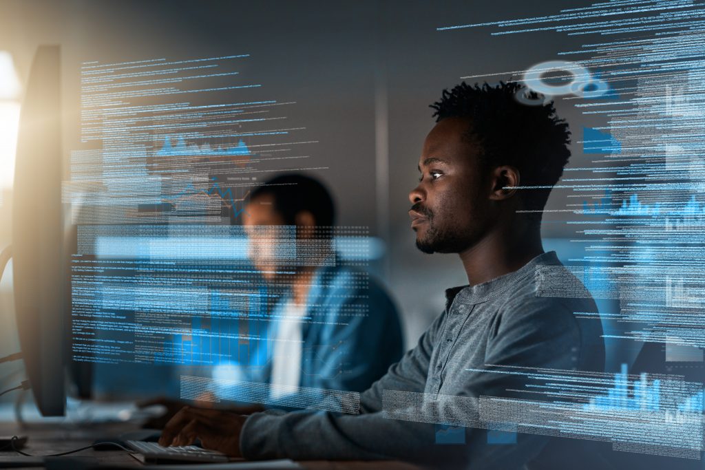 Two young men working in a finance lab. Data from their screens is overlaid on top of the image.